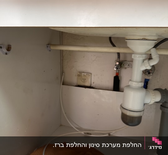 כיור עם צנרת מתחת לארון מטבח